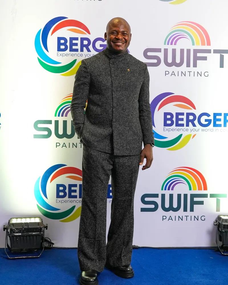 The Corporate Emcee in a black textured suit on the Berger Paints red carpet