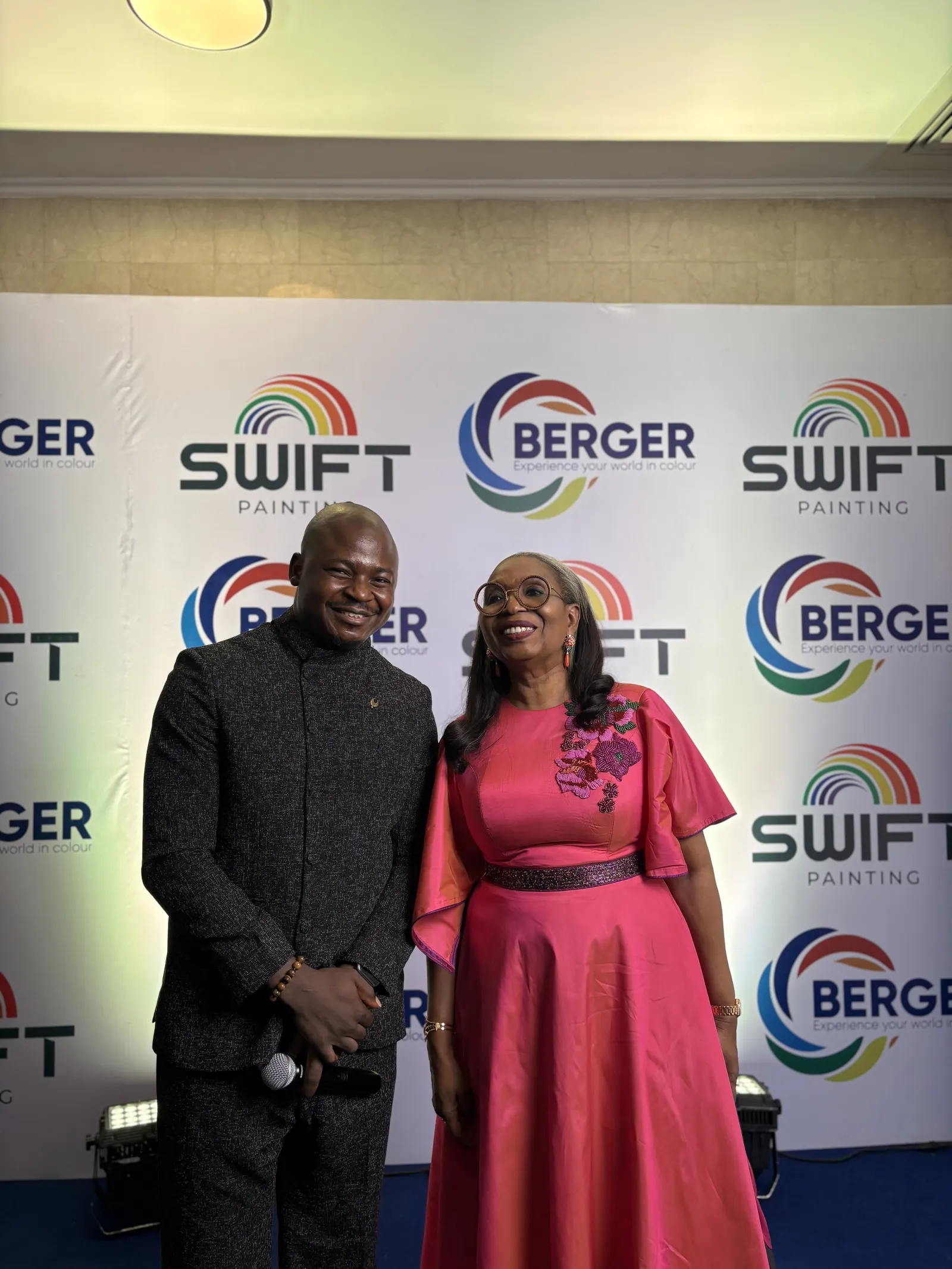 The Corporate Emcee, microphone in hand, with a guest on the red carpet at a Berger Paints event